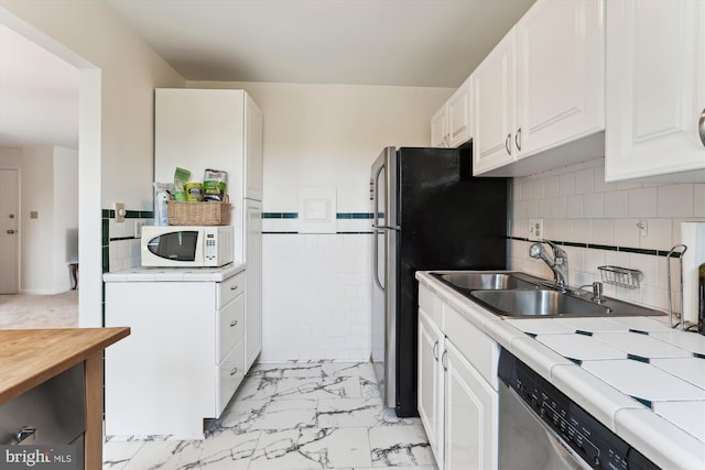 614 Sligo Ave Unit 504, Silver Spring, MD 20910 - kitchen with a sink, stainless steel appliances, light marble finish flooring, and white cabinetry