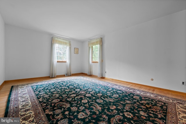 empty room with light wood finished floors and baseboards