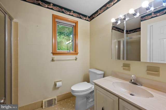 full bath with a shower stall, tile patterned floors, toilet, vanity, and baseboards