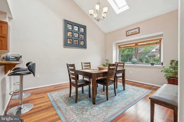 2307 Bright Leaf Way, Baltimore, MD 21209 - dining room featuring a skylight, a chandelier, wood finished floors, baseboards, and high vaulted ceiling