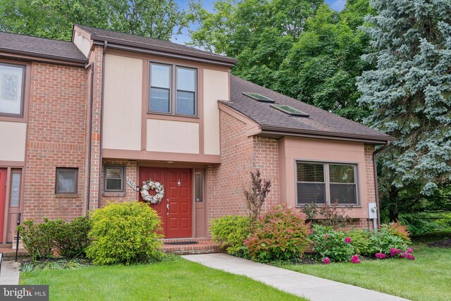 2307 Bright Leaf Way, Baltimore, MD 21209 - view of front facade with brick siding, a front yard, and roof with shingles