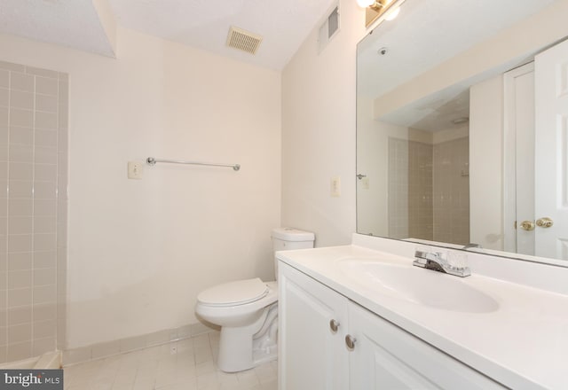 19202 Cross Ridge Dr, Germantown, MD 20874 - bathroom featuring toilet, vanity, a tile shower, and tile patterned flooring