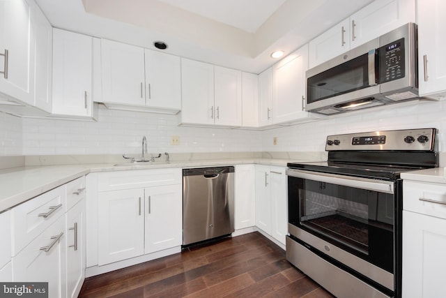 19202 Cross Ridge Dr, Germantown, MD 20874 - kitchen featuring appliances with stainless steel finishes, a sink, dark wood-style floors, white cabinets, and light stone countertops
