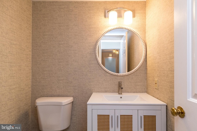 bathroom with toilet and vanity
