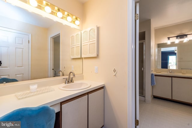 full bath with vanity and tile patterned flooring