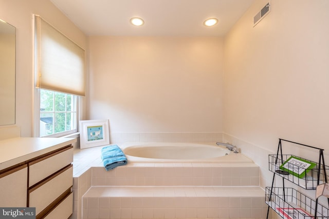 bathroom with a bath and vanity