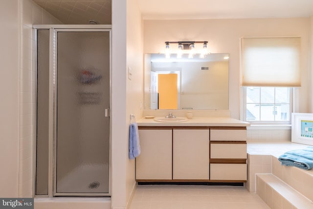 full bath featuring a stall shower, vanity, and tile patterned floors
