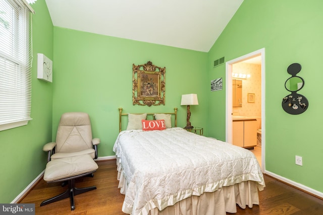 bedroom with wood finished floors, vaulted ceiling, ensuite bathroom, and baseboards