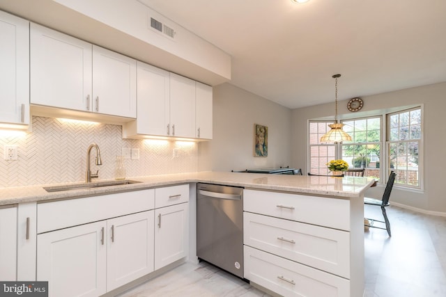 kitchen with dishwasher, a sink, a peninsula, and white cabinetry