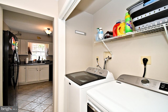 laundry area featuring independent washer and dryer and light tile patterned floors