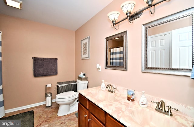 bathroom featuring baseboards, toilet, double vanity, and a shower with shower curtain