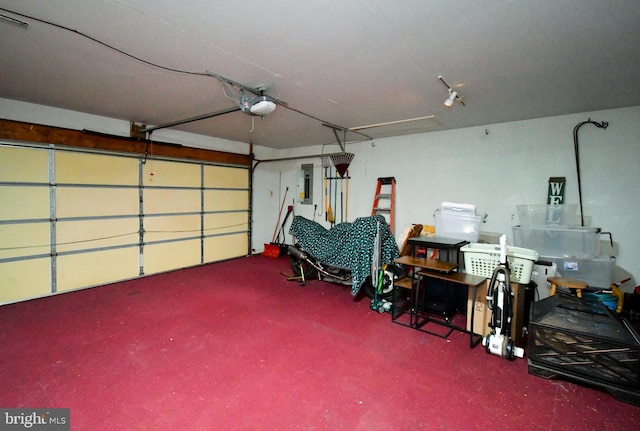 garage with a garage door opener and electric panel