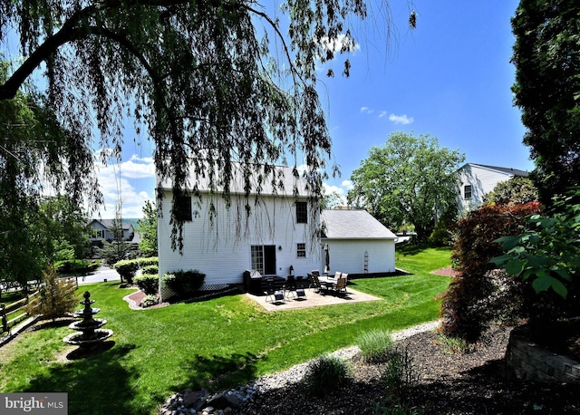 back of house with a patio, a yard, and an outdoor fire pit