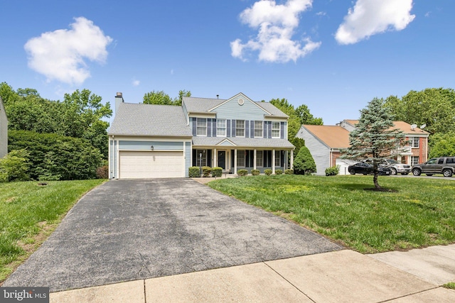 16110 Amethyst Ln, Bowie, MD 20716 - view of front of home featuring asphalt driveway, a porch, an attached garage, a front lawn, and a chimney