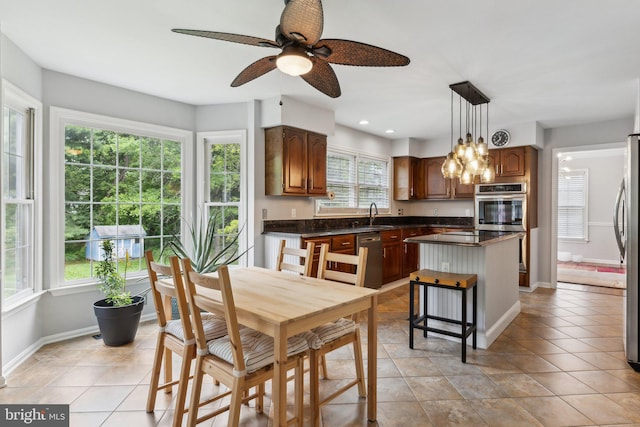 16110 Amethyst Ln, Bowie, MD 20716 - kitchen with dark countertops, a sink, a ceiling fan, a center island, and appliances with stainless steel finishes