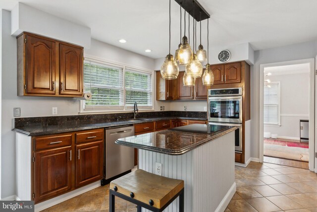 16110 Amethyst Ln, Bowie, MD 20716 - kitchen with appliances with stainless steel finishes, a kitchen island, pendant lighting, dark stone countertops, and a sink