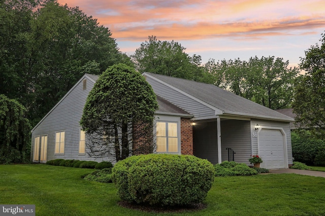 38 Falmouth Dr, Mount Laurel, NJ 08054 - property exterior at dusk with an attached garage, a lawn, and concrete driveway