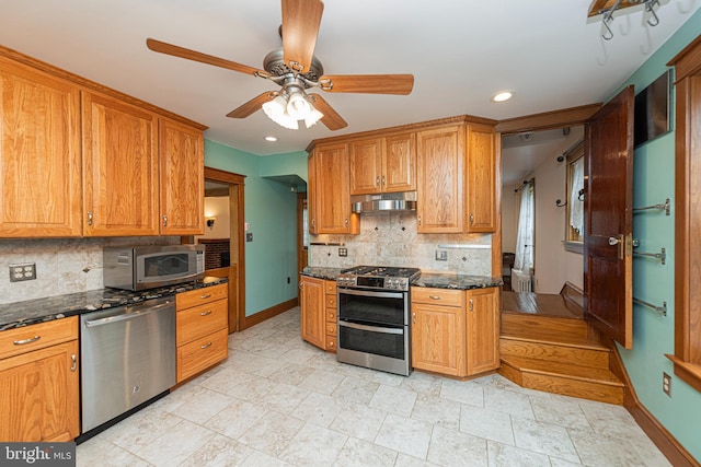 116 N Brobst St, Shillington, PA 19607 - kitchen with stainless steel appliances, under cabinet range hood, baseboards, a ceiling fan, and backsplash