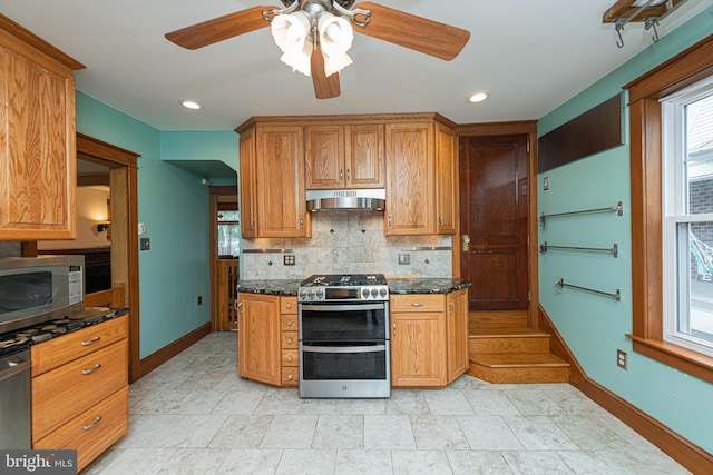 116 N Brobst St, Shillington, PA 19607 - kitchen with stainless steel appliances, tasteful backsplash, a ceiling fan, baseboards, and wall chimney range hood