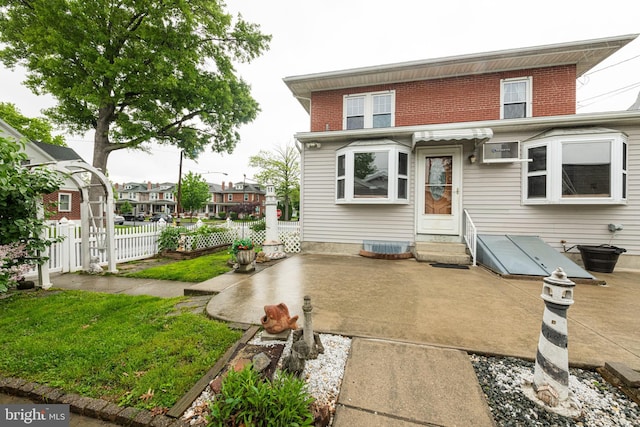 116 N Brobst St, Shillington, PA 19607 - back of house with entry steps, a patio, fence, and brick siding