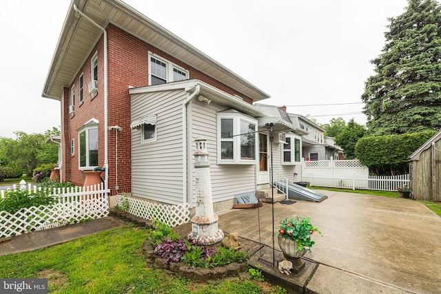 116 N Brobst St, Shillington, PA 19607 - view of front of house with fence, a patio area, entry steps, and brick siding