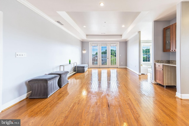 12800 Libertys Delight Dr Unit 403, Bowie, MD 20720 - unfurnished living room with a raised ceiling, light wood-style floors, french doors, and baseboards