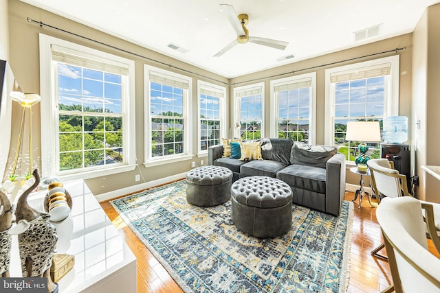 sunroom / solarium featuring healthy amount of natural light and wood-type flooring