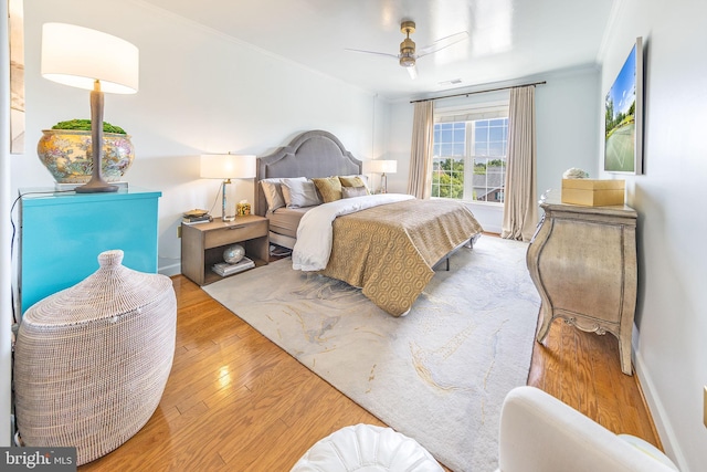 12800 Libertys Delight Dr Unit 403, Bowie, MD 20720 - bedroom with crown molding, wood finished floors, and a ceiling fan