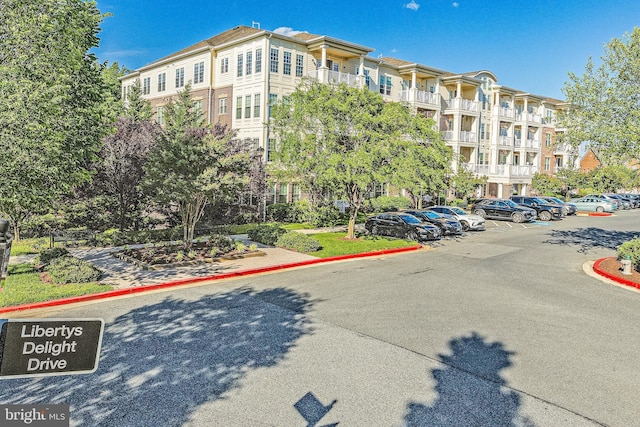 view of apartment building / complex with uncovered parking