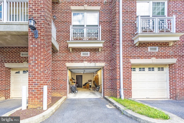 12800 Libertys Delight Dr Unit 403, Bowie, MD 20720 - view of exterior entry featuring brick siding and an attached garage