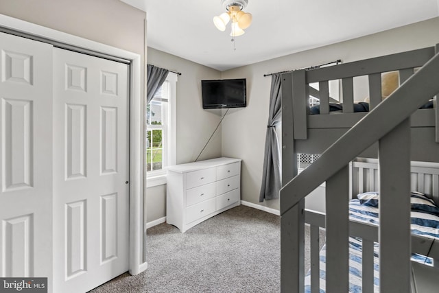 bedroom with carpet flooring and baseboards