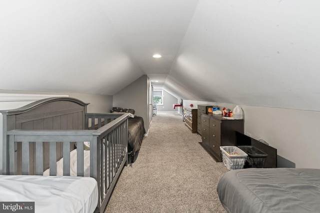 bedroom with vaulted ceiling and carpet flooring