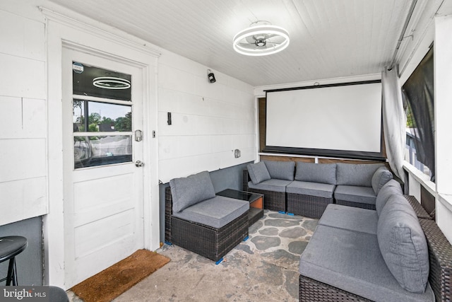 home theater room featuring unfinished concrete flooring