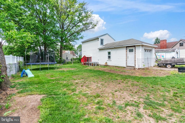 view of yard with a trampoline and an attached garage