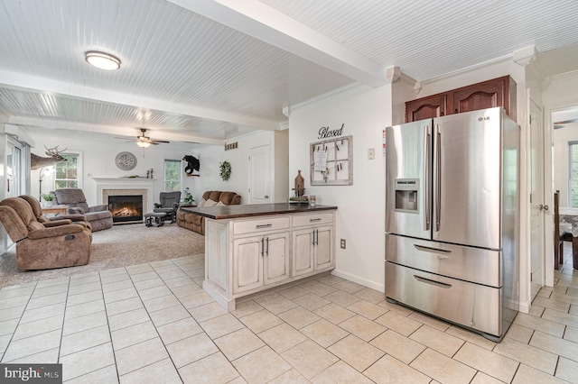 1070 George Brown Rd, Millerstown, PA 17062 - kitchen featuring stainless steel refrigerator with ice dispenser, a ceiling fan, dark countertops, a glass covered fireplace, and light tile patterned floors