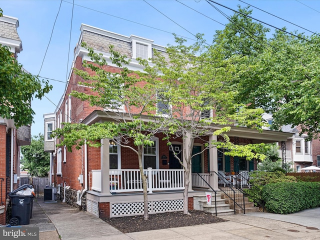 1503 W Tenth St, Wilmington, DE 19806 - view of front of property with a porch, brick siding, mansard roof, and central air condition unit