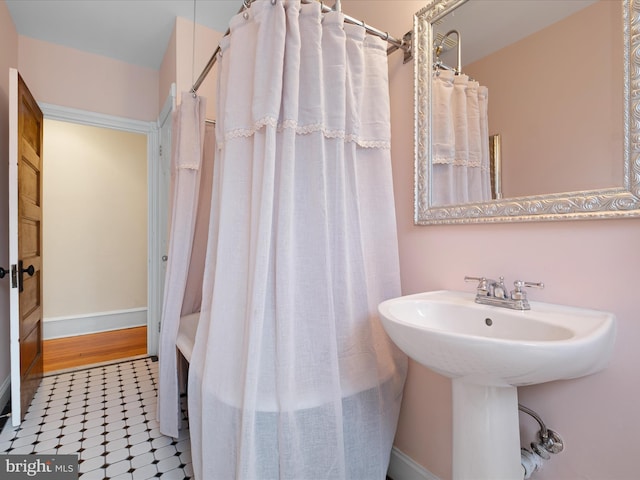 1503 W Tenth St, Wilmington, DE 19806 - bathroom featuring tile patterned floors, a sink, curtained shower, and baseboards