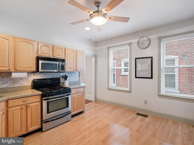 1503 W Tenth St, Wilmington, DE 19806 - kitchen with stainless steel appliances, light brown cabinets, light countertops, light wood-style floors, and backsplash