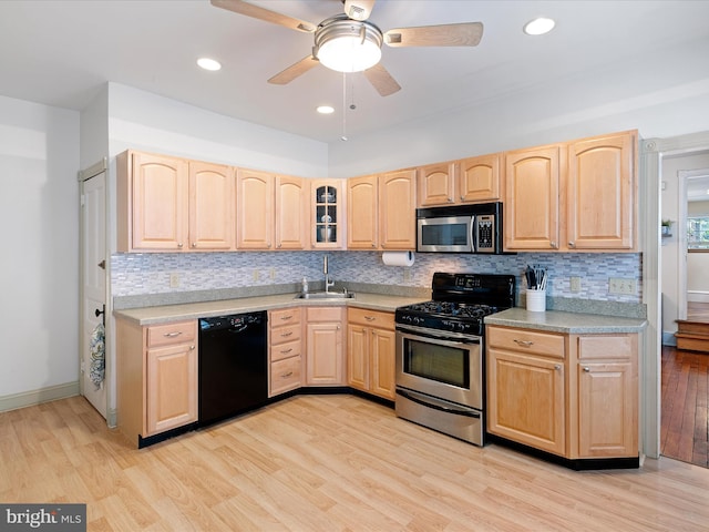 1503 W Tenth St, Wilmington, DE 19806 - kitchen with stainless steel appliances, light brown cabinetry, a sink, light wood finished floors, and light countertops