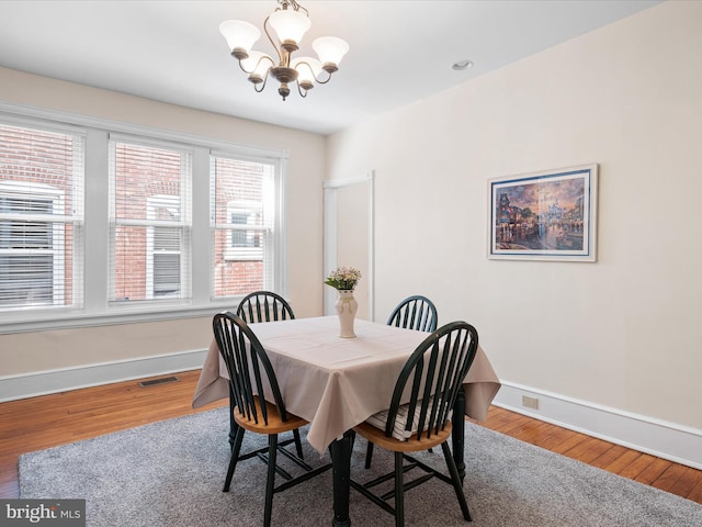 1503 W Tenth St, Wilmington, DE 19806 - dining area featuring a chandelier, baseboards, and wood finished floors