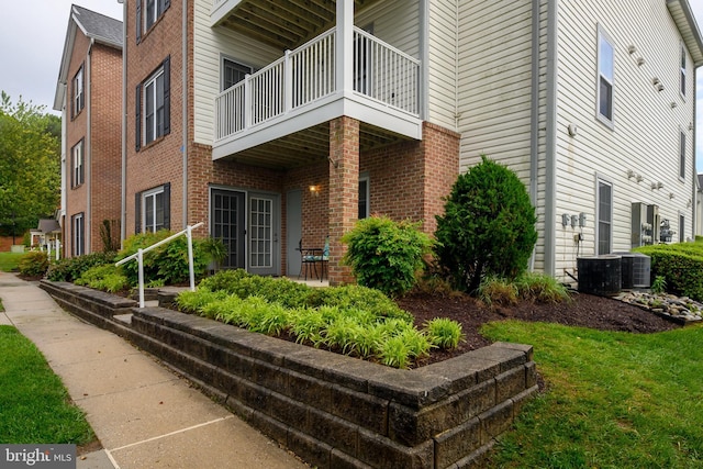 2021 Rudy Serra Dr Unit 1D, Eldersburg, MD 21784 - view of side of home featuring a balcony, central air condition unit, and brick siding