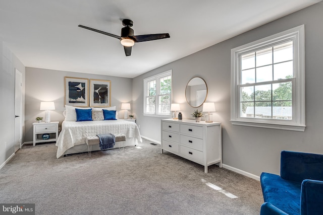 bedroom with carpet, baseboards, and a ceiling fan