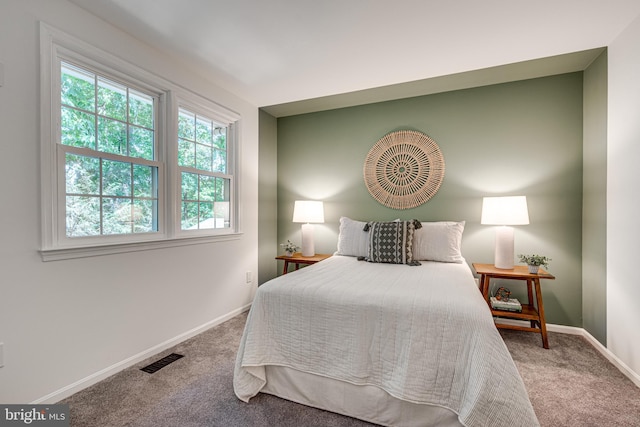 carpeted bedroom featuring baseboards