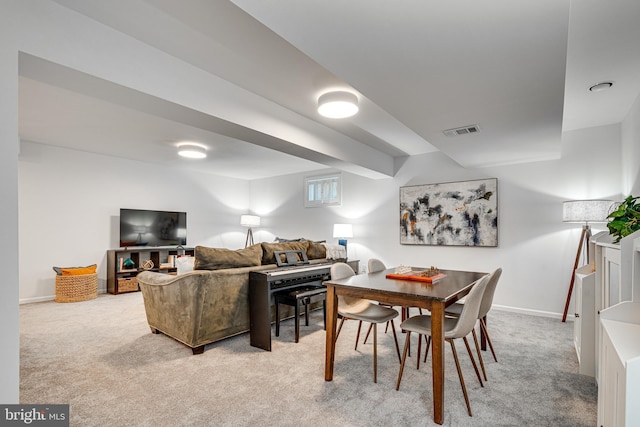 dining space with light carpet and baseboards