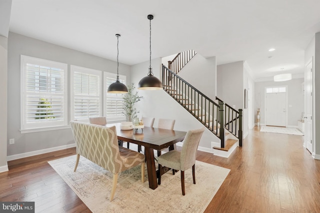 dining room with stairs, baseboards, wood-type flooring, and recessed lighting