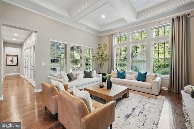 living room featuring coffered ceiling, hardwood / wood-style floors, crown molding, baseboards, and beamed ceiling