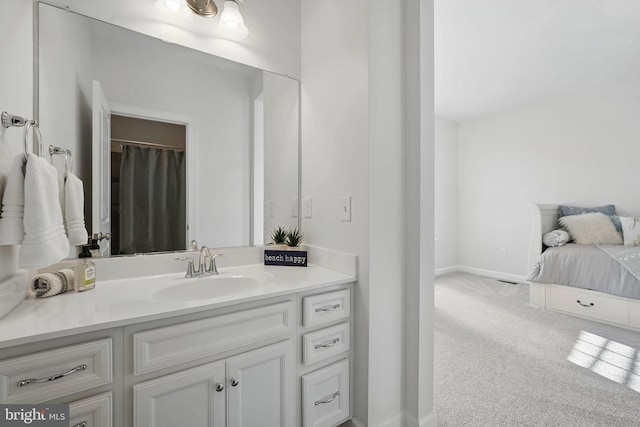 full bathroom with vanity and baseboards