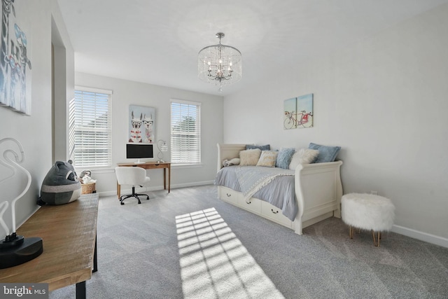 carpeted bedroom featuring a chandelier, baseboards, and an office area