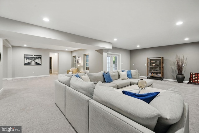 living area featuring light carpet, recessed lighting, and baseboards