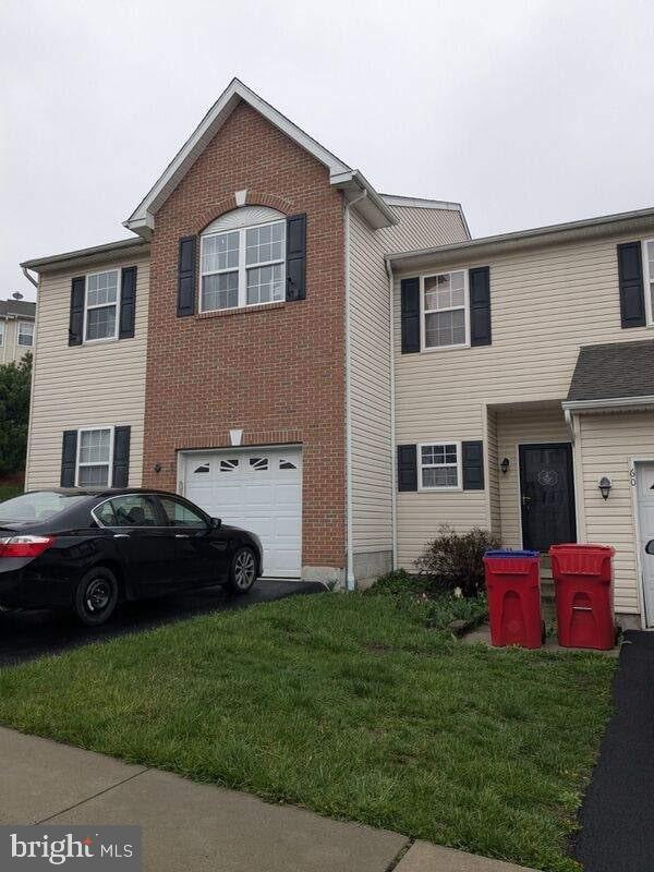 view of front of property with a garage and a front lawn
